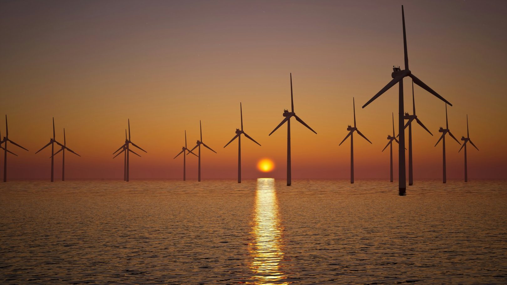 Wind & Renewables Wind turbines on the water at sunset, reflecting light across the waves.